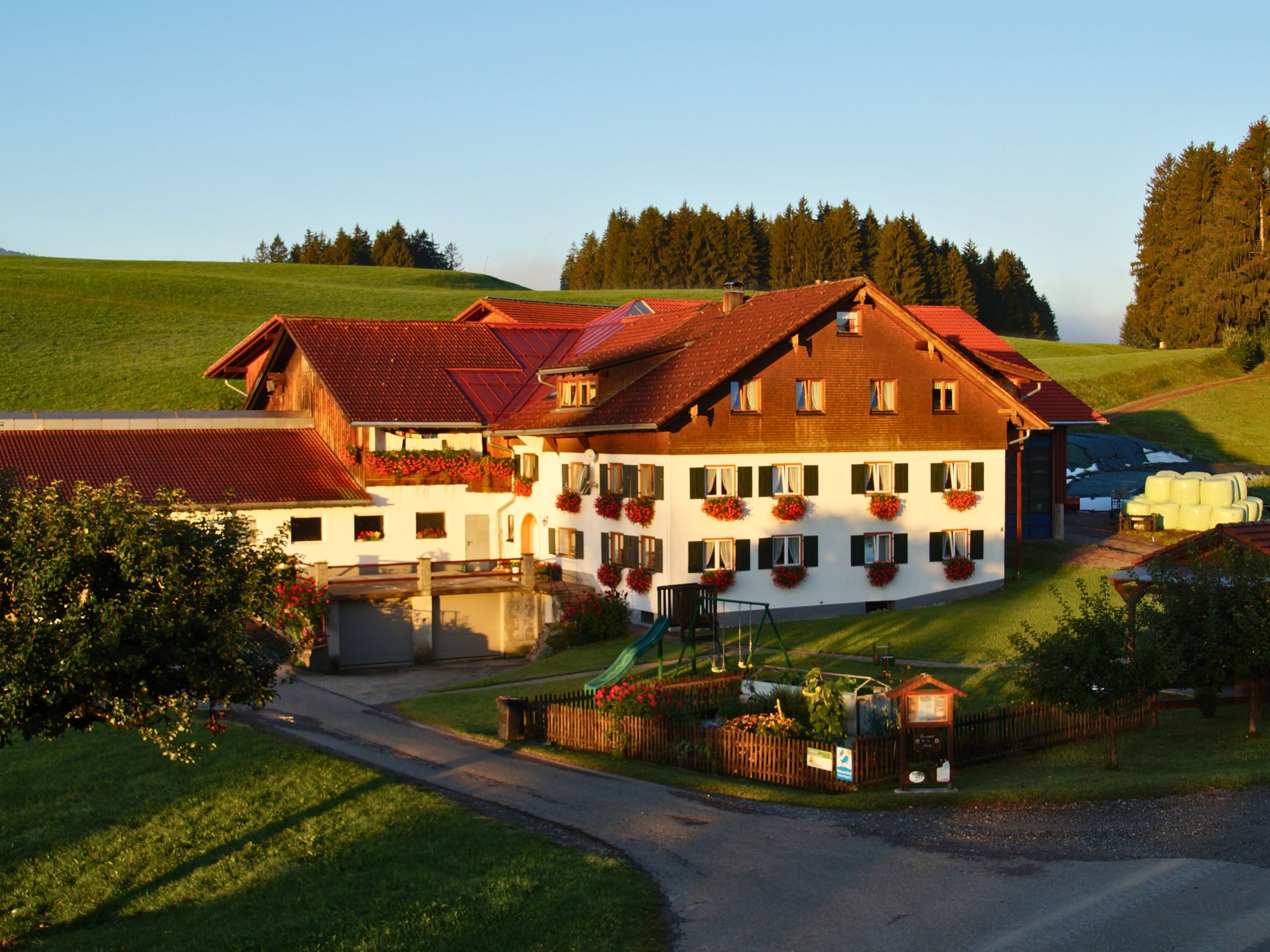 Sonnenaufgang über dem Ferienhof Eger im Allgäu – ruhige Morgenstimmung auf dem Land mit Wiesen, Wald und Weitblick